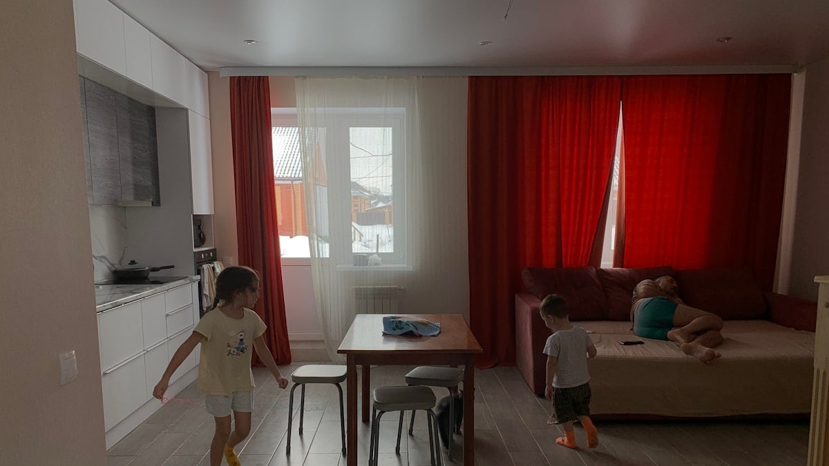 a little boy and a little girl playing in a living room